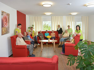 Senioren mit dem Pflegeteam im Gemeinschaftsraum der Senioren-WG